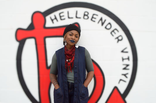 Janeka in front of the Hellbender Vinyl logo in Pittsburgh, Pennsylvania