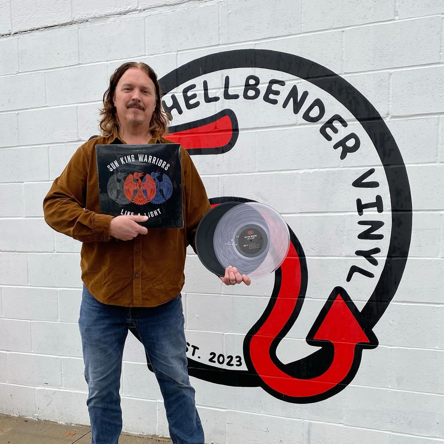 Jim Donovan holiding a clear vinyl record made by Hellbender Vinyl