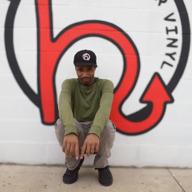 Head of QC Buscrates wearing a Hellbender Vinyl baseball cap