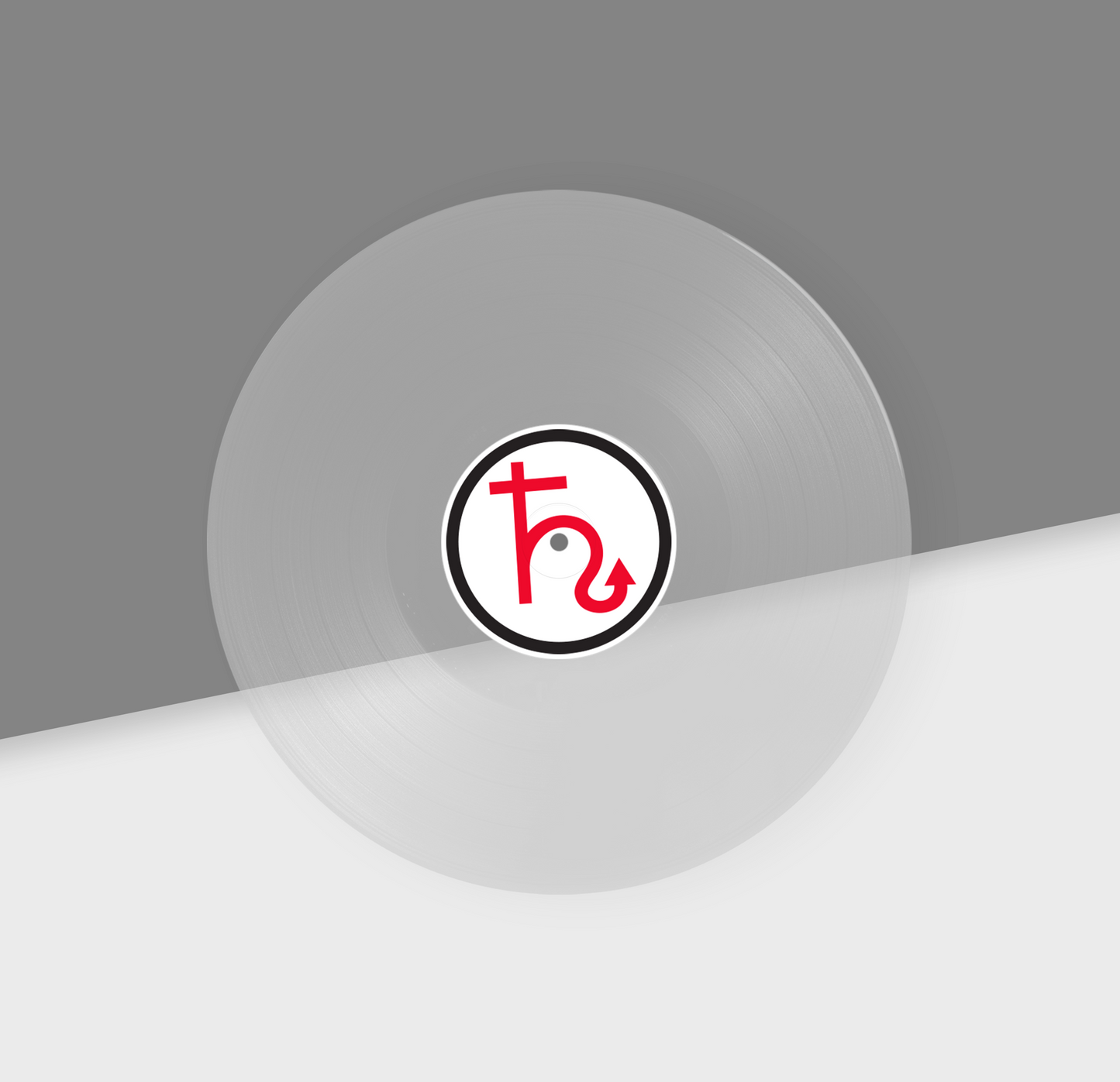 A clear vinyl record with a red and black label in the center, placed on a grey background.