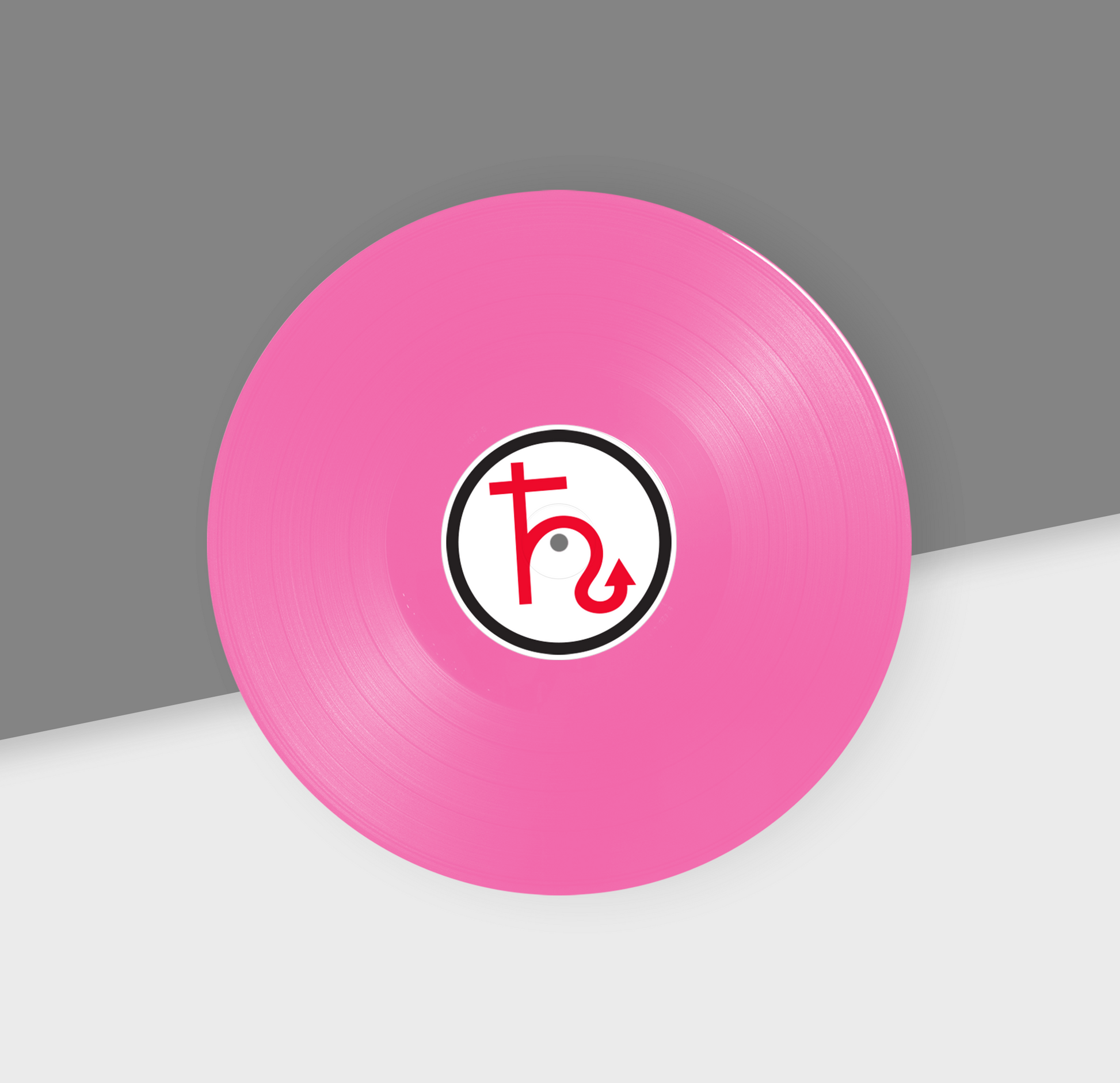 A pink 12-inch vinyl record with a black and white label in the center, placed on a gray and white background.