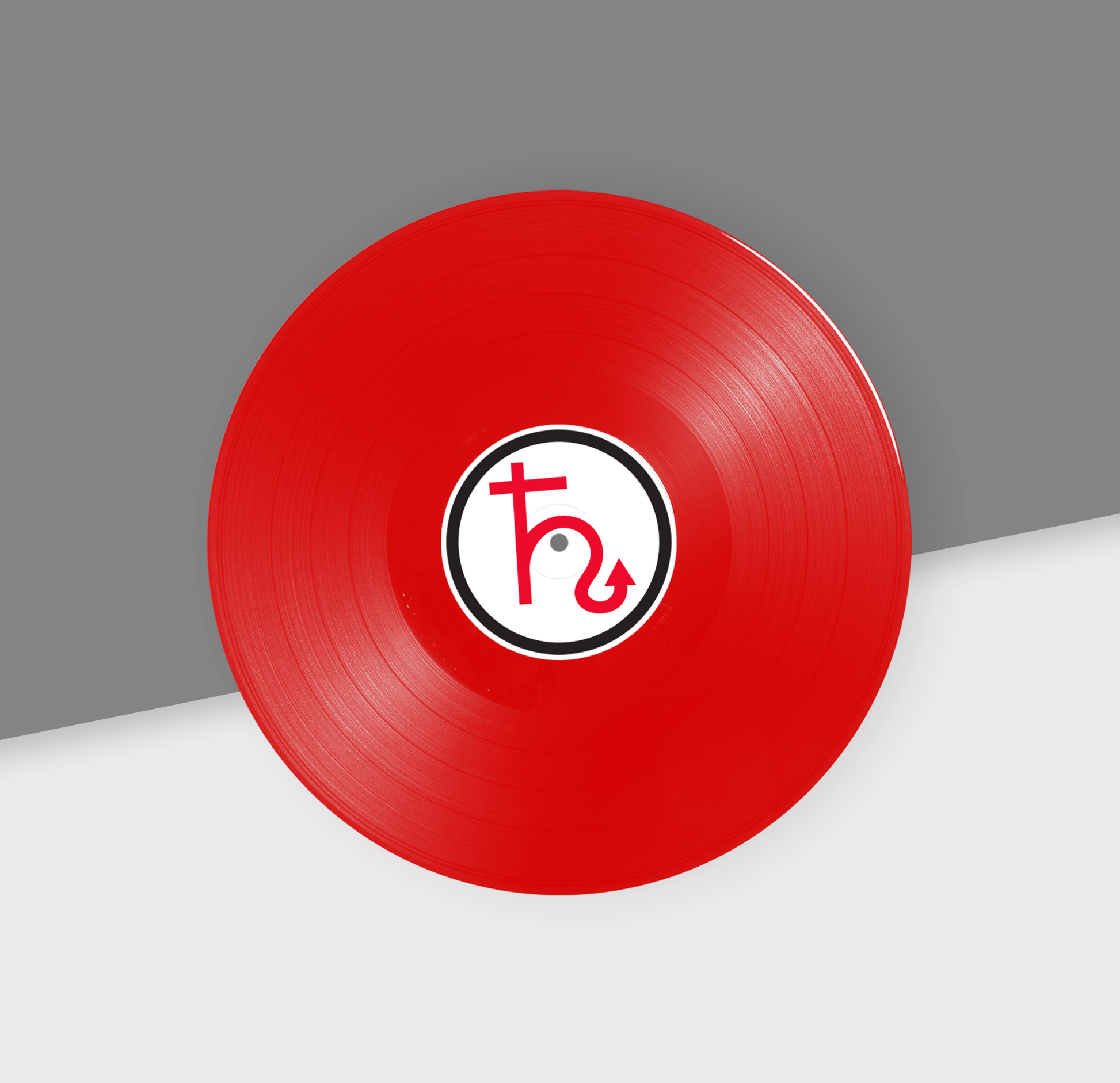 A red 12-inch vinyl record with a white label in the center.