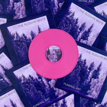 Vinyl record with pink label surrounded by 'The Russian White' album covers