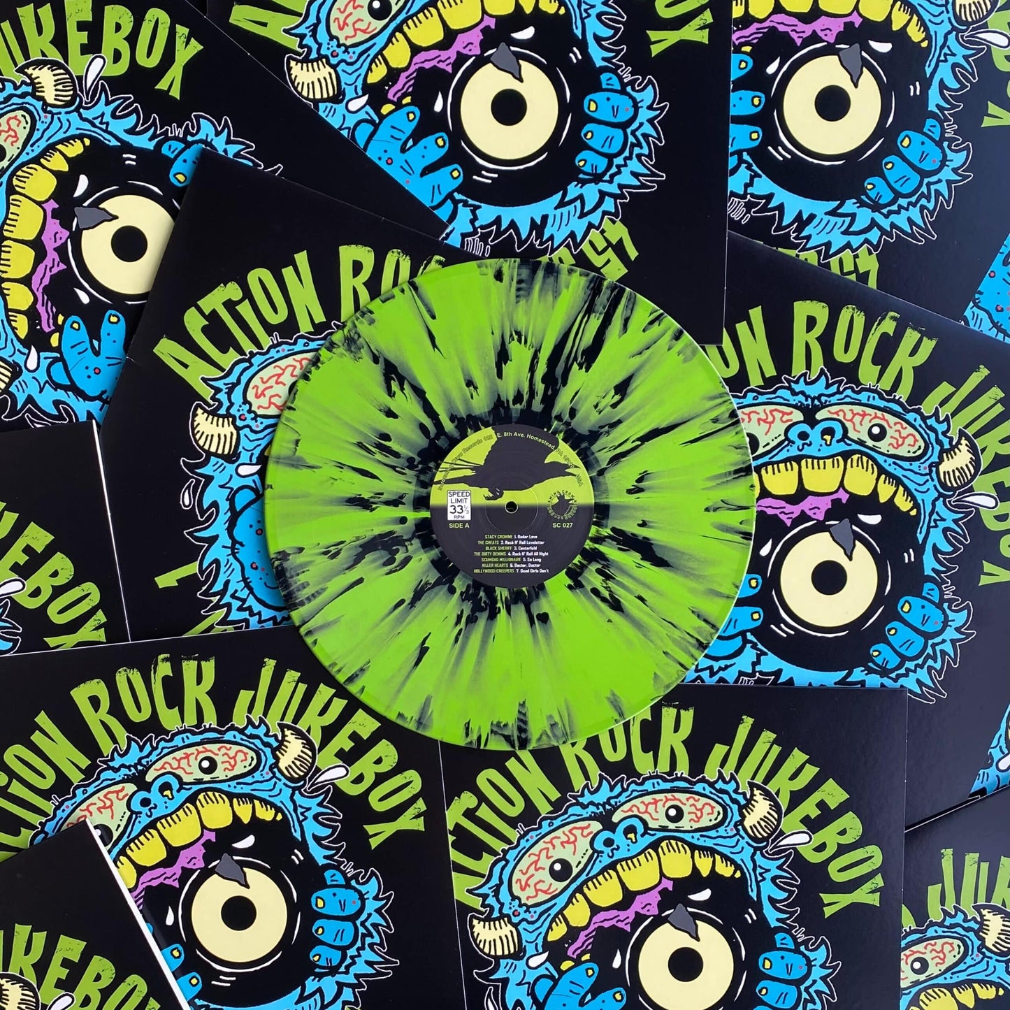 Vinyl record with colorful sleeve design featuring 'Action Rock Jukebox' text and graphics.