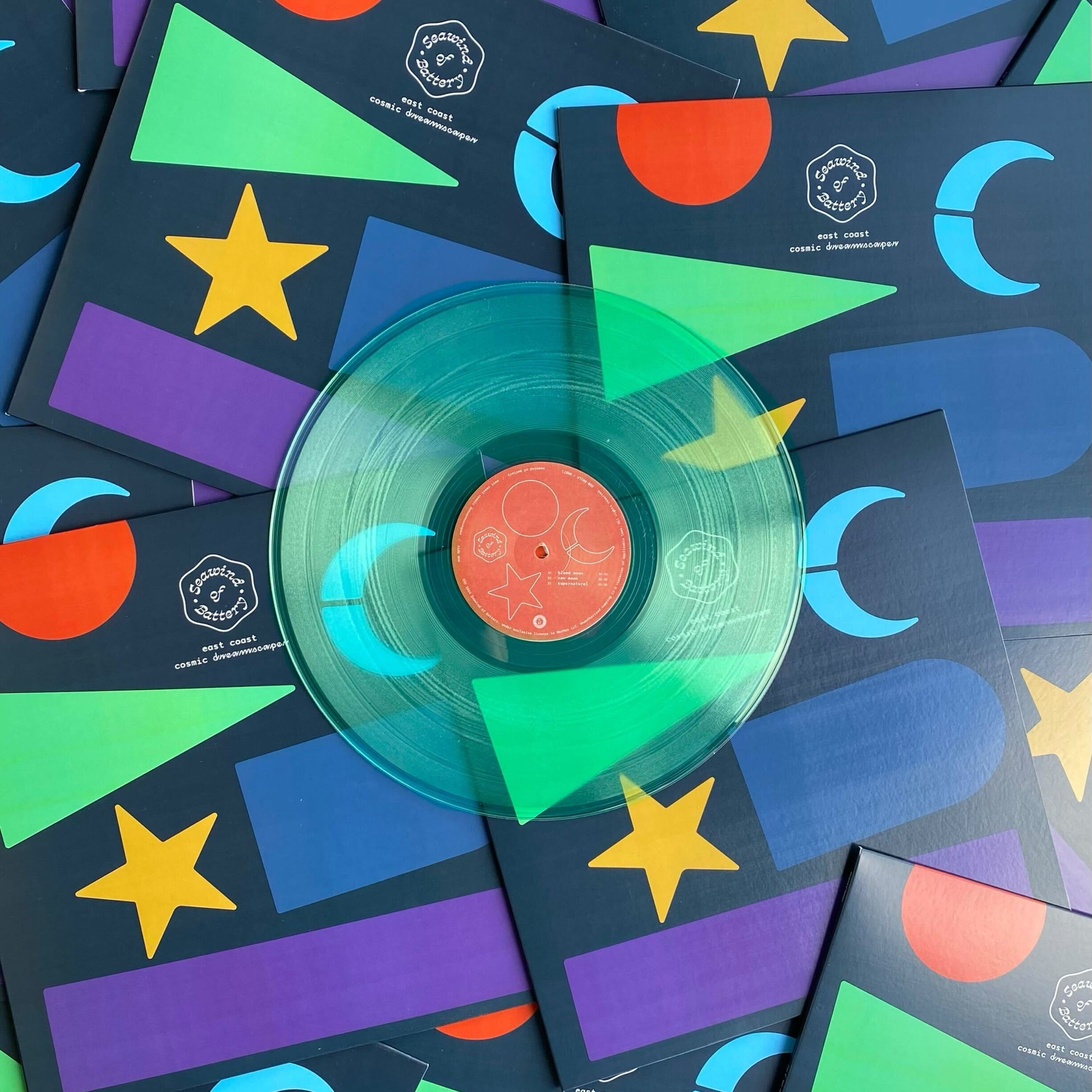 A 12" coke bottle clear vinyl record pressed by Hellbender Vinyl