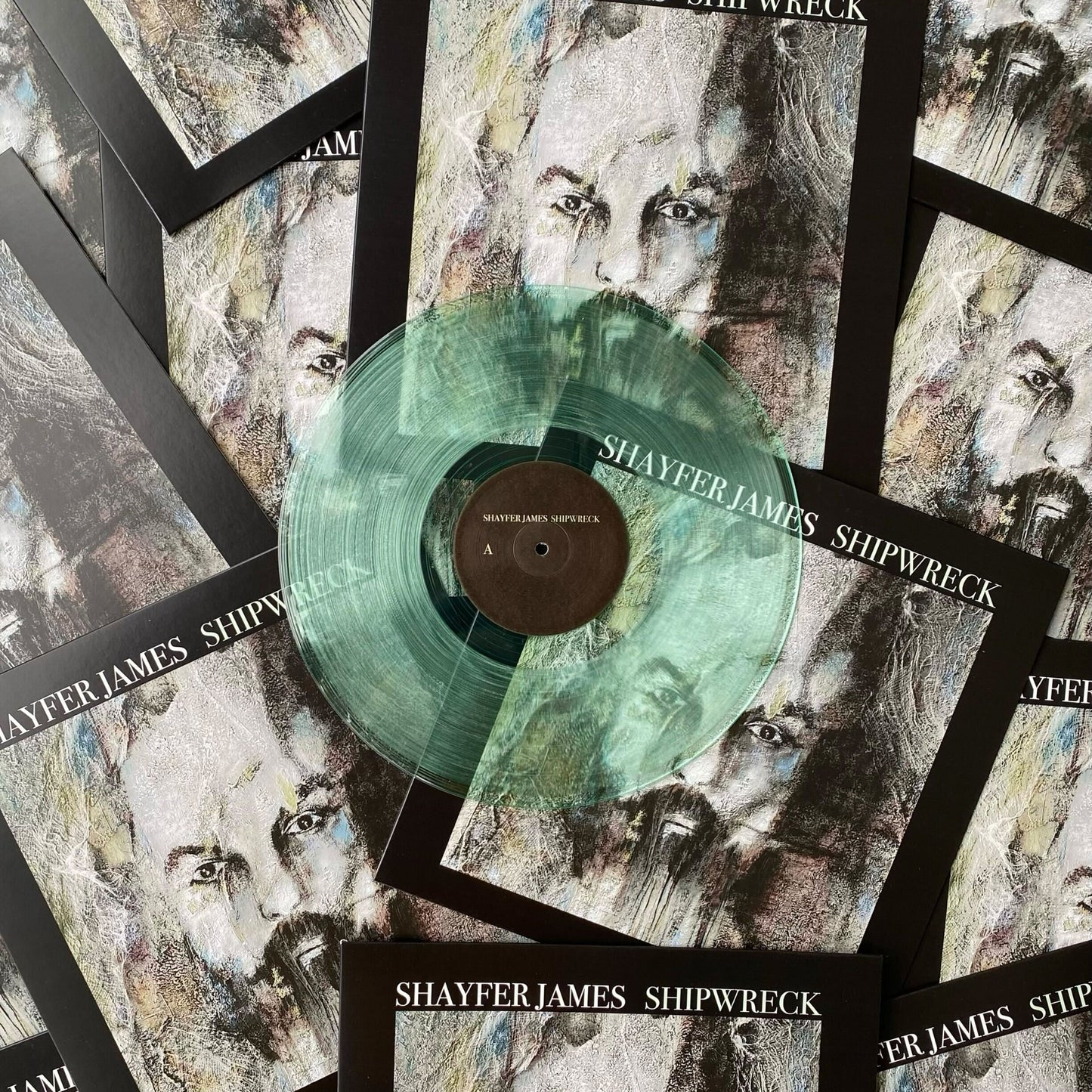 A 12" coke bottle clear vinyl record pressed by Hellbender Vinyl