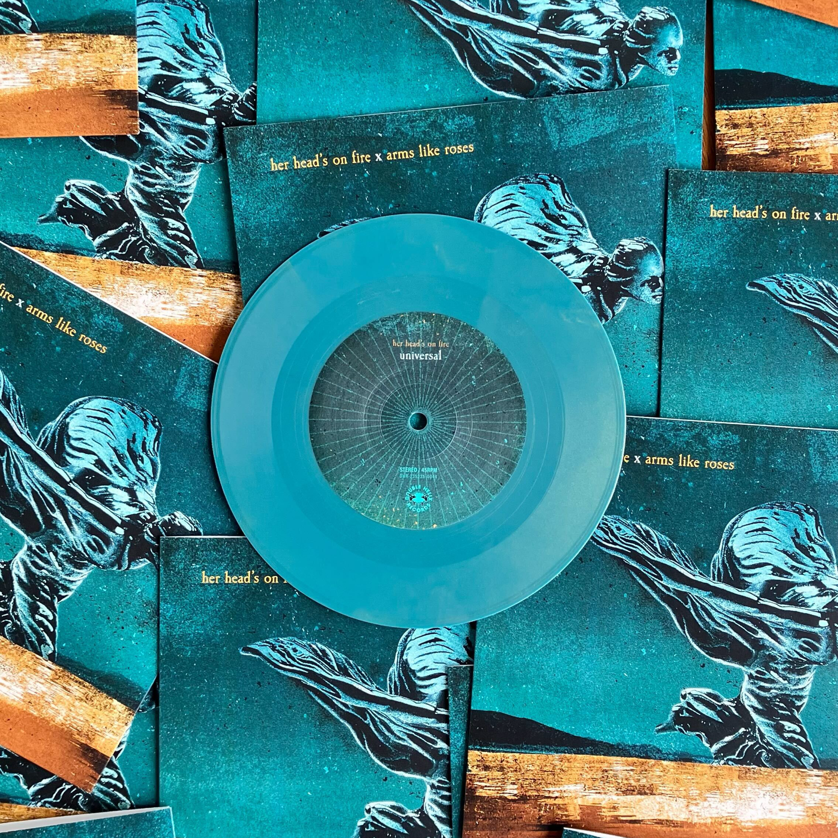 Turquoise vinyl record with packaging on background