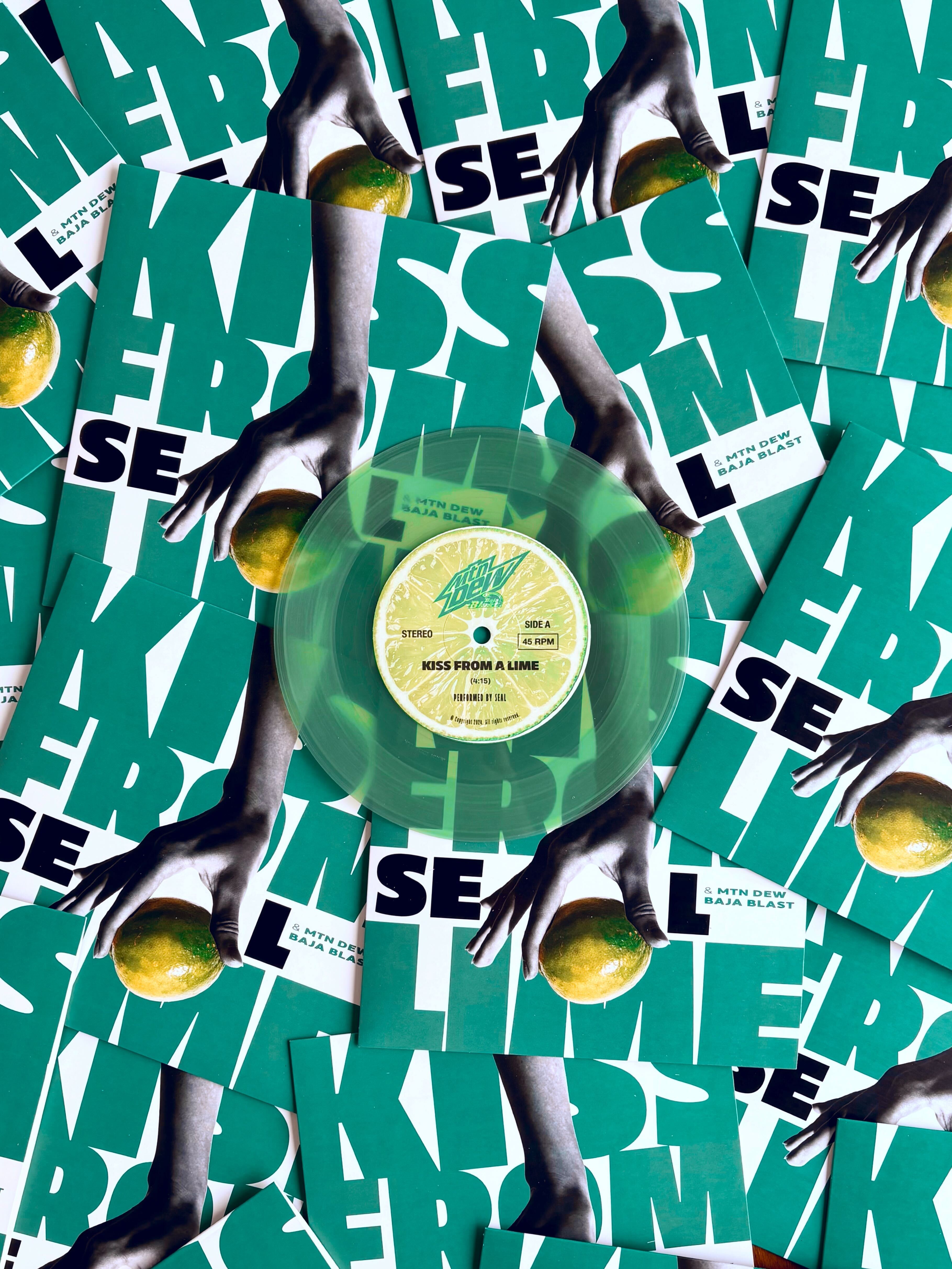 Close-up of Mountain Dew Baja Blast vinyl record, part of corporate merch options.