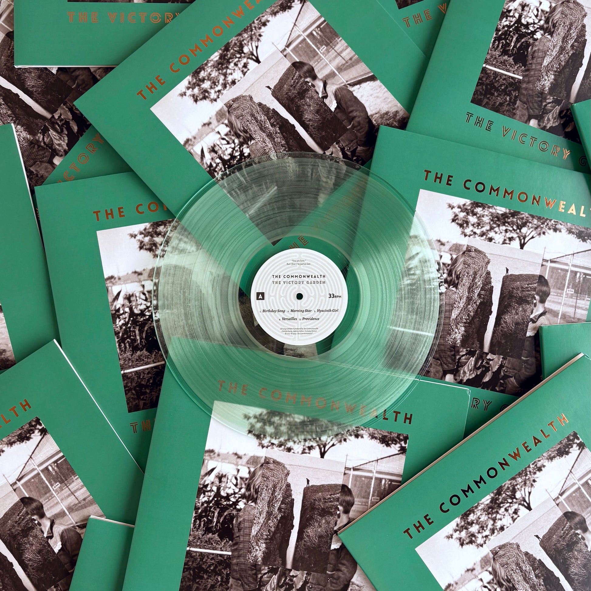 A 12" coke bottle clear vinyl record pressed by Hellbender Vinyl