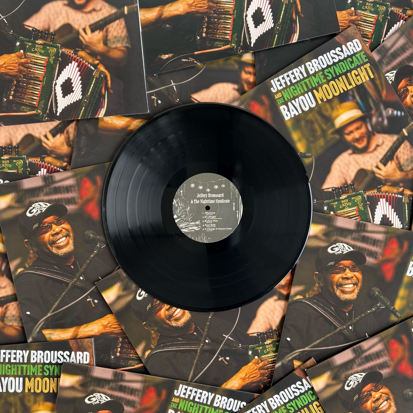 Vinyl record with a cover featuring a person playing an accordion, surrounded by multiple album covers.