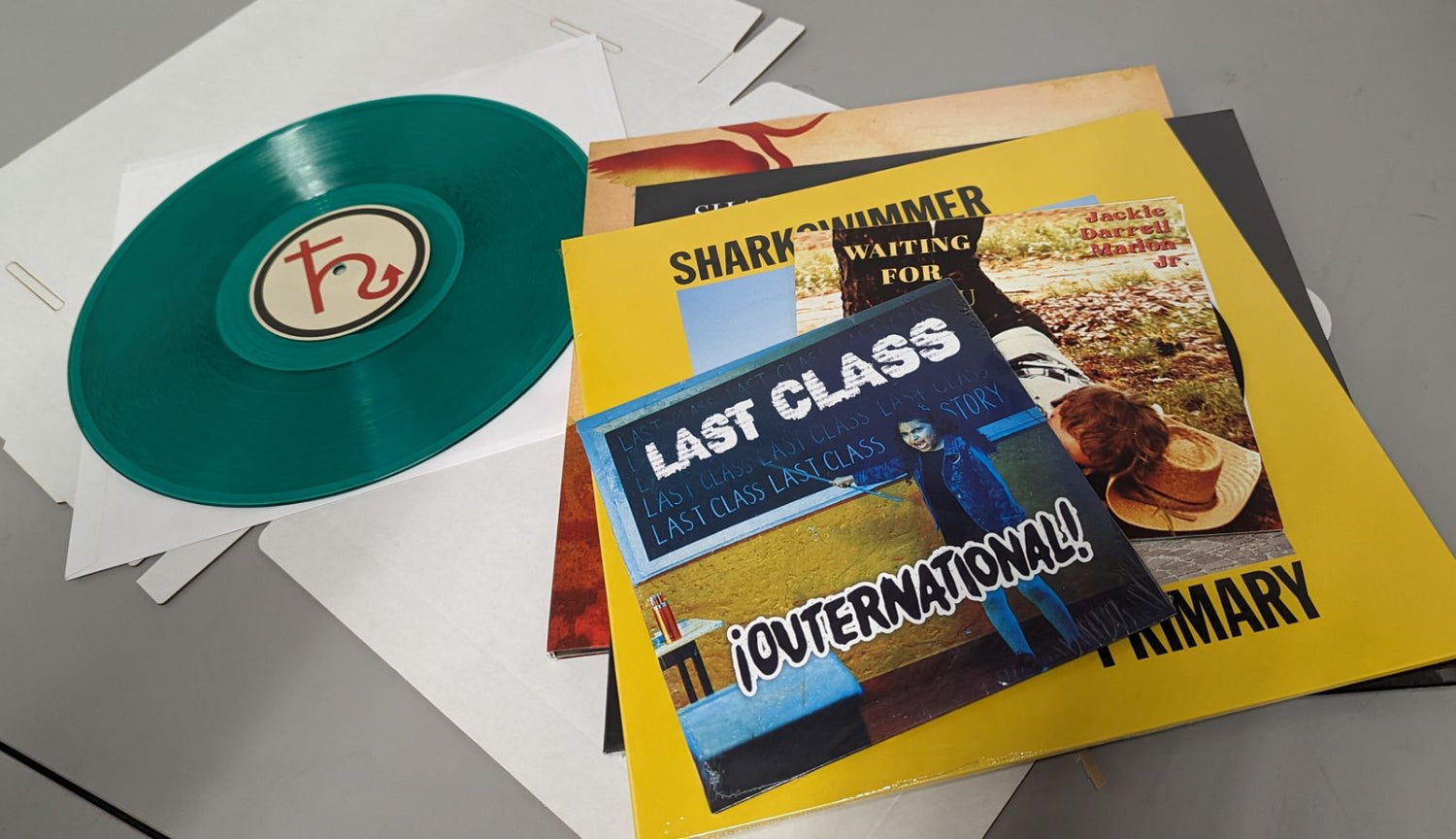 Hellbender Vinyl sample records: green vinyl record and various album art